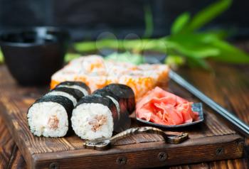 sushi with wasabi and ginger on a table