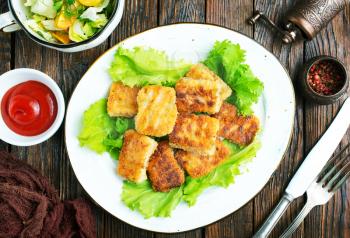 fish nuggets with latuk salad on plate, fried nuggets
