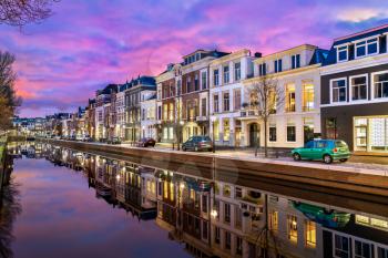 Traditional houses beside a canal in the Hague at sunset. The Netherlands