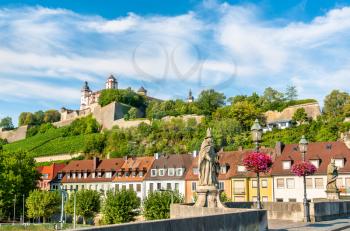 Statue on the Alte Mainbrucke and Marienberg Fortress in Wurzburg - Bavaria, Germany