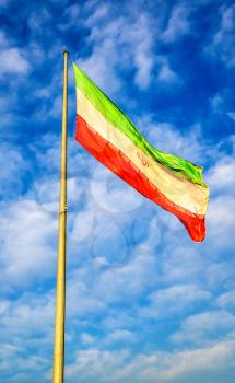 Iran flag against blue sky in Tehran