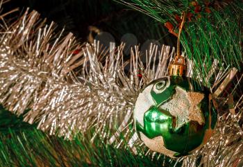 Green Christmas ball with star with tinsel