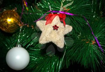 Christmas Toy furry star on the artificial Christmas tree
