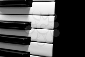 Part of the musical keyboard on a black bacground