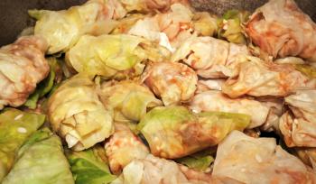 Raw stuffed cabbage rolls with raw cabbage leaves