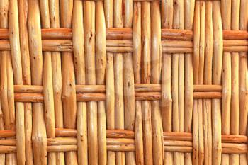 Simple wicker wooden background made of twigs closeup