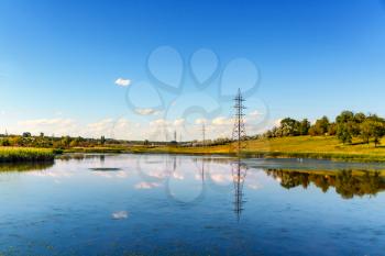 Landscape with blue sky and the reflection of the sky in the lake