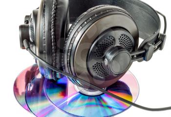 Compact discs and headphones close up isolated on white background