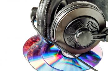 Compact discs and headphones close up isolated on white background