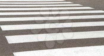A worn-out pedestrian crossing on a country road