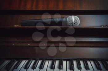 Stylized piano and wireless microphone close up