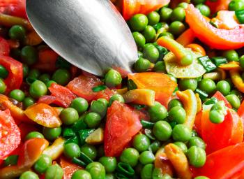 Tomato salad with mushrooms and green peas close-up