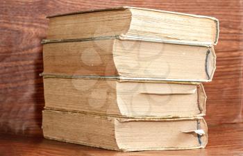 Stack of old books on wooden background