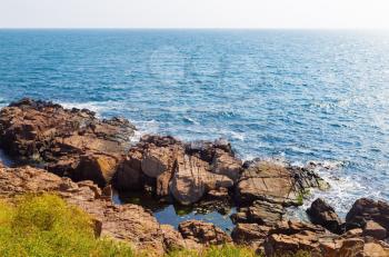Beautiful picturesque seascape. Black Sea coast in bright sunny day. Rocky coast with large stone and.blue sea water.