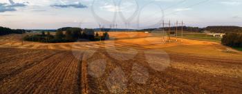 Rural landscape at sunset. Plowed field after harvest.