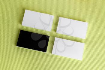 Photo of blank business cards on green background. Template for ID. Top view.