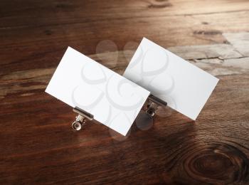Blank business cards. Photo of blank white business cards on vintage wooden background. Mockup for branding identity. Blank corporate identity template.