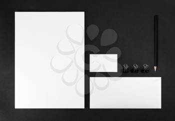 Photo of blank stationery set on black background. Corporate identity template for design presentations and portfolios. Mock-up for branding identity. Top view.