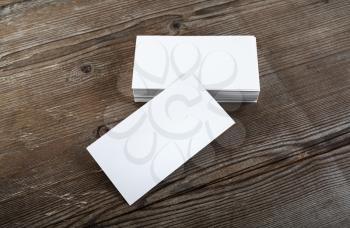 Photo of blank business cards on a wooden background. Template for branding identity. Top view.