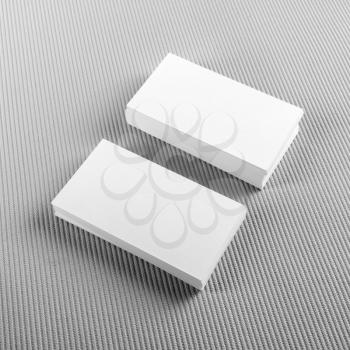 Photo of blank business cards with soft shadows on gray background. Template for ID. Top view.