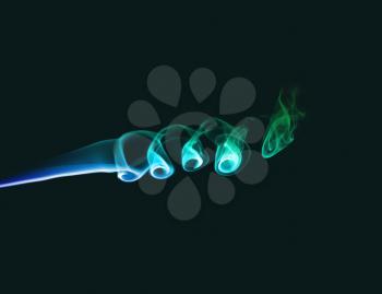 Abstract bright colored smoke on a dark green background.