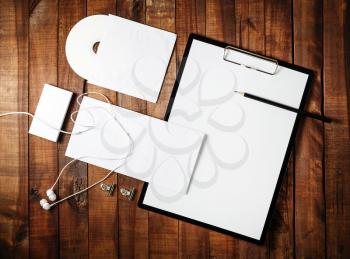 Blank mock-up for design portfolios on wooden table background. Blank ID set. Photo of blank stationery set. Top view.