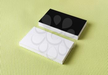 Several black and white business cards on a green background.