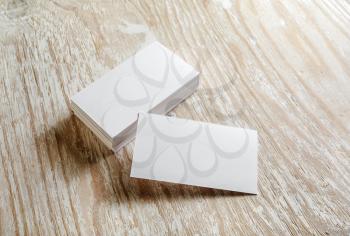Photo of blank business cards on light wooden background. Mock-up for branding identity. 