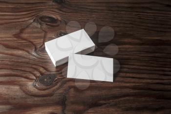 Photo of blank business cards on brown wooden background. Template for branding identyty.