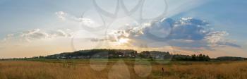 A picturesque sunset in the countryside. Panoramic rural landscape,