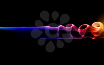 Abstract colorful smoke on black on a dark background.