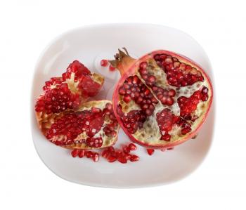 Pomegranate on a white rectangular plate. Top view. Isolated with clipping path.