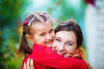 Embrace mother with  little daughter. Mom and child girl. Happy family. Shallow depth of field. Selective focus.