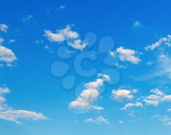 Blue sky background with a few white clouds.