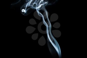 Photo of abstract smoke swirls on black background. Studio shot.