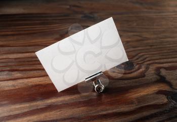 Photo of blank business card in paper clip. Blank template for branding identity for design presentations and portfolios.