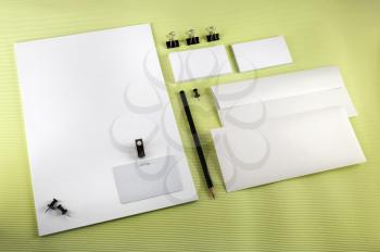 Blank corporate identity set on green background. Top view.