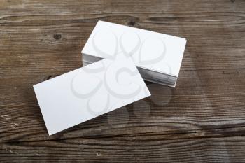 Photo of blank business cards on a wooden background. Template for ID.