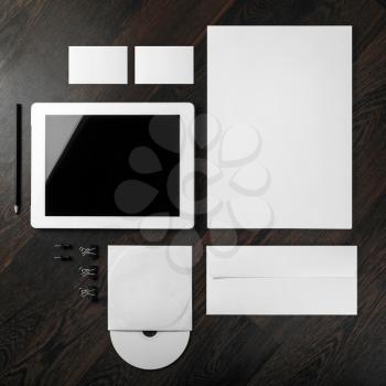 Corporate identity template on dark wooden background. For design presentations and portfolios. Top view.
