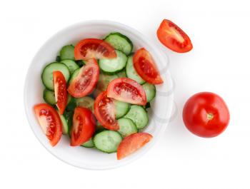 Sliced tomatoes and cucumbers on a white plate. Clipping path