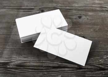 Photo of blank business cards with soft shadows on wooden background. For design presentations and portfolios. Template for ID.