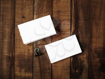 Photo of blank business cards on a wooden background. Template for ID. Top view.