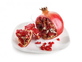 Ripe appetizing pomegranate on a white plate. Isolated with clipping path.