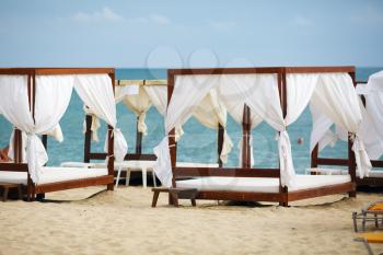 White beach canopies. Luxury beach tents at the resort for relaxation and spa treatments.
