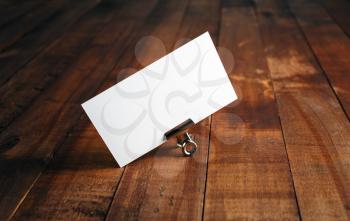 Blank business card on vintage wooden background. Photo of blank business card. Mock-up for branding identity for designers.