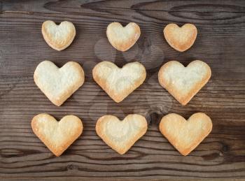 Heart shaped cookies on wooden background. Top view.