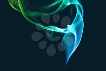Abstract blue and green smoke on a dark background.