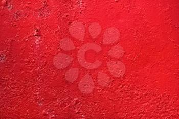 Red background. Bright painted old textured wall.