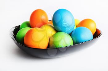 Easter eggs in a black ceramic plate. Shallow depth of field. Selective focus.