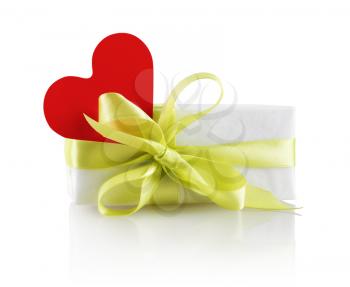 Festive gift box with ribbon and red heart on a white background. Isolated with clipping path.